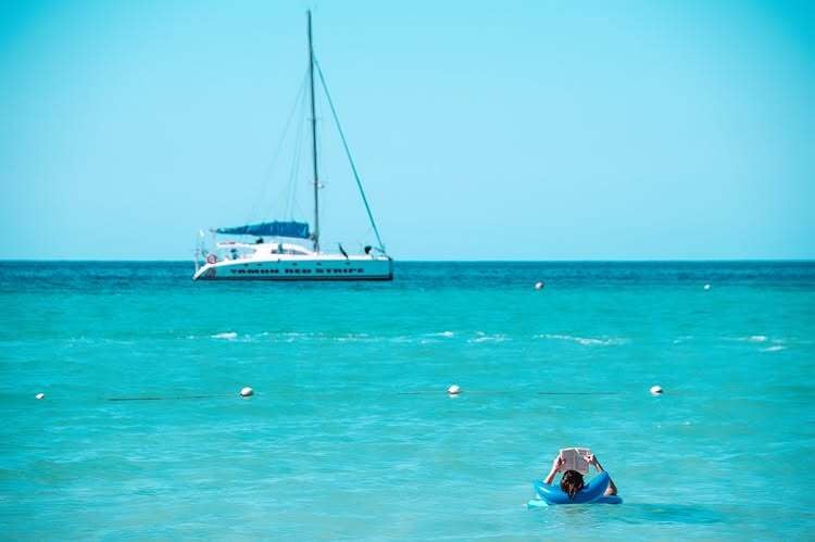 Person enjoying reading a book in Caribbean Beach